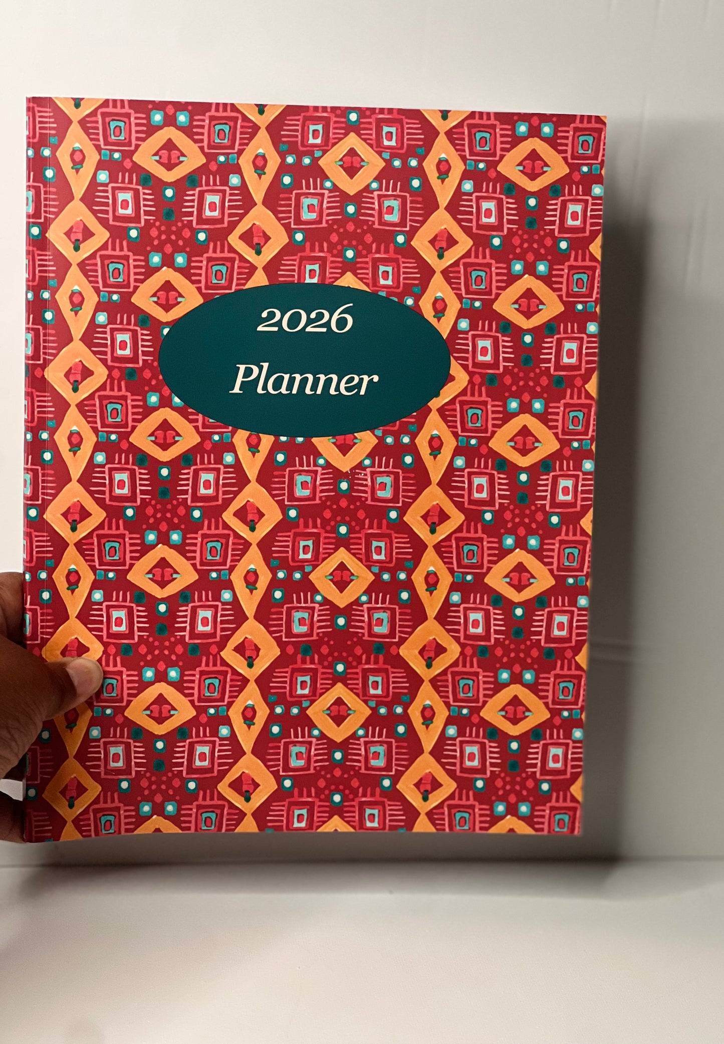 2026 planner with a red and orange geometric pattern on a white background